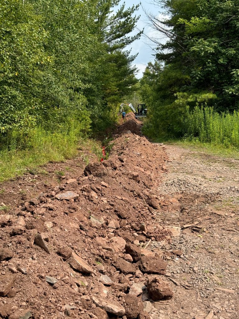 A new trench with conduit and new power lines.